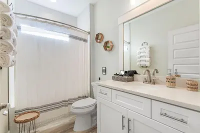 a white bathroom with a toilet and a shower at Emerald-Gem-Inn • Laguna Haven/Beach Home! in Panama City Beach