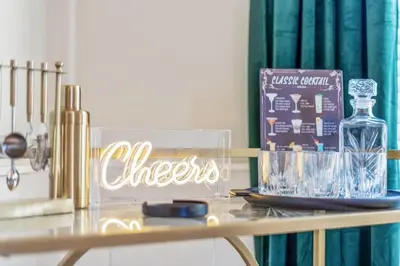 a table with a glass bottle and a sign on it at Emerald-Gem-Inn • Laguna Haven/Beach Home! in Panama City Beach