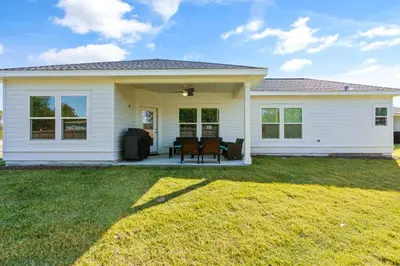 a white house with a lawn in front of it at Emerald-Gem-Inn • Laguna Haven/Beach Home! in Panama City Beach