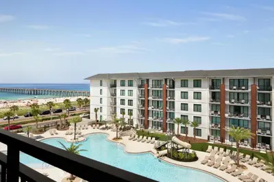 a view of a resort with a pool and the beach at Embassy Suites By Hilton Panama City Beach Resort in Panama City Beach