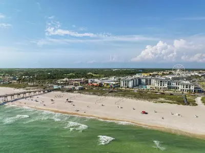 an aerial view of a beach with people and buildings at Embassy Suites By Hilton Panama City Beach Resort in Panama City Beach