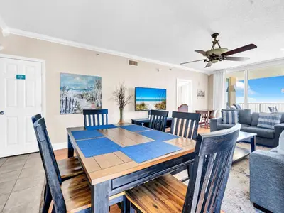 a dining room and living room with a table and chairs at Majestic Beach Towers 1-1701 in Panama City Beach