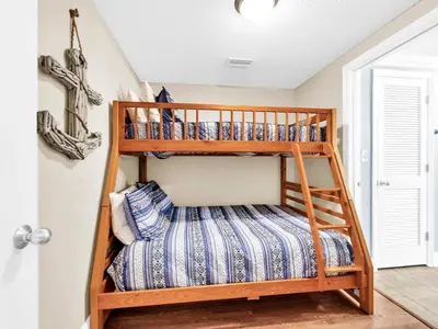 a bunk bed in a childs room with a ladder at Majestic Beach Towers 1-1701 in Panama City Beach
