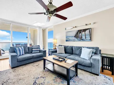 a living room with two couches and a ceiling fan at Majestic Beach Towers 1-1701 in Panama City Beach