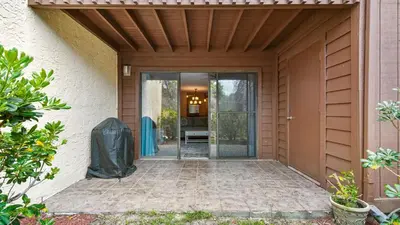 an entrance to a house with a glass door at Beach Walk 10C by Sand Seeker Vacations in Panama City Beach