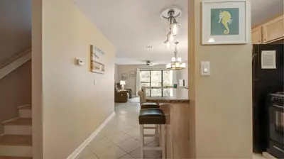 a hallway leading to a kitchen and a living room at Beach Walk 10C by Sand Seeker Vacations in Panama City Beach