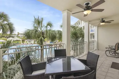 a patio with a table and chairs on a balcony at Villas at Seacrest by Panhandle Getaways in Seacrest