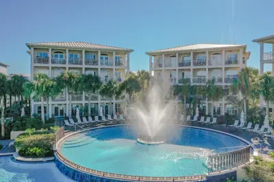 a fountain in the middle of a pool in front of two buildings at Villas at Seacrest by Panhandle Getaways in Seacrest