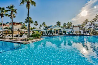 a large pool at a resort with palm trees at Villas at Seacrest by Panhandle Getaways in Seacrest