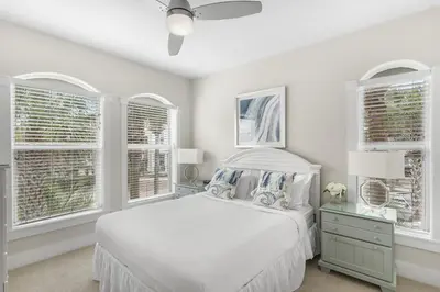 a white bedroom with a bed and windows at Villas at Seacrest by Panhandle Getaways in Seacrest