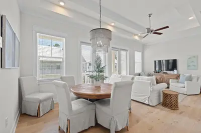 a dining room and living room with a table and chairs at Prominence North #89C - Sun Times in Watersound Beach