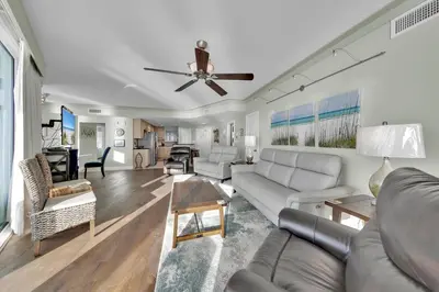 a living room with a couch and a ceiling fan at Palazzo 408 in Panama City Beach