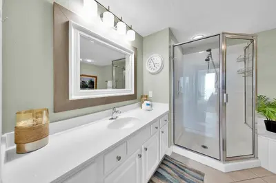 a white bathroom with a sink and a shower at Palazzo 408 in Panama City Beach