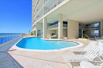 a swimming pool in front of a building at Palazzo 408 in Panama City Beach