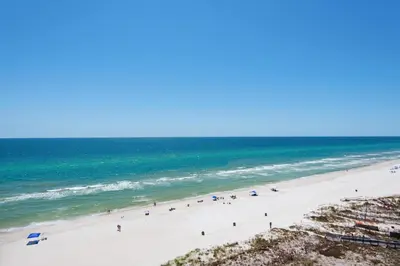 a group of people on a beach with the ocean at Palazzo 408 in Panama City Beach