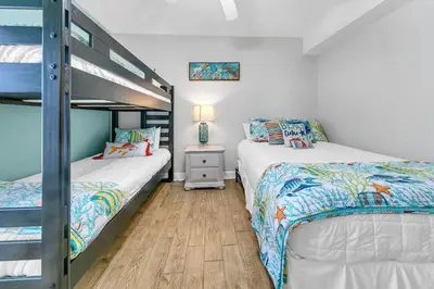 two beds in a bedroom with a bunk bed at Emerald Isle 1201 in Panama City Beach