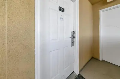 a white door with a sign on it in a room at Emerald Isle 1201 in Panama City Beach