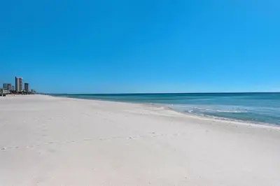 an empty beach with the ocean in the background at Emerald Isle 1201 in Panama City Beach