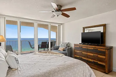 a bedroom with a bed and a flat screen tv at Enjoy A Birds Eye View at Panama City Beach in Panama City Beach