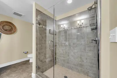 a bathroom with a glass shower with a toilet at Sterling Breeze 1204 in Panama City Beach