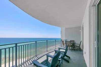 a balcony with chairs and a view of the ocean at Sterling Breeze 1204 in Panama City Beach