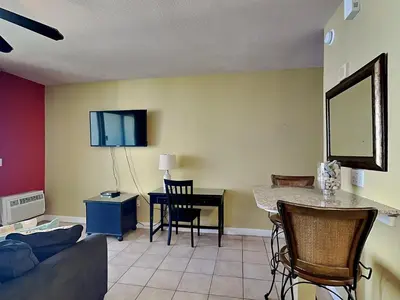 a living room with a couch and a table at Shores of Panama #1406 in Panama City Beach