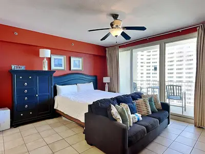 a bedroom with a bed and a couch at Shores of Panama #1406 in Panama City Beach