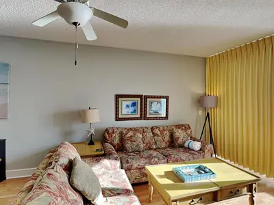 a living room with a couch and a table at Majestic Beach Towers I #1004 in Panama City Beach