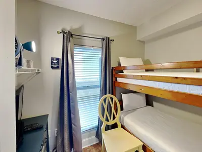a bedroom with two bunk beds and a window at Majestic Beach Towers I #1004 in Panama City Beach