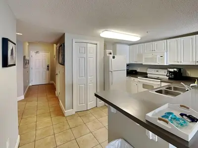 a kitchen with white cabinets and a counter top at Majestic Beach Towers I #1004 in Panama City Beach