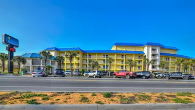 a large yellow building with cars parked in front of it at Continental 206 in Panama City Beach