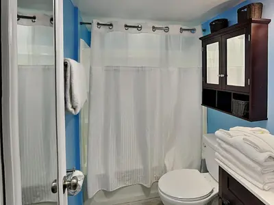 a bathroom with a white shower curtain and a toilet at Continental 206 in Panama City Beach
