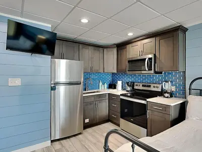 a kitchen with a stainless steel refrigerator and cabinets at Continental 206 in Panama City Beach
