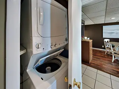 a washer and dryer in a kitchen next to a room at Edgewater Windward #204 in Panama City Beach