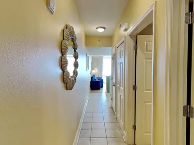 a hallway with a horseshoe hanging on a wall at Majestic Beach Towers I #1414 in Panama City Beach