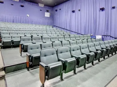 an empty auditorium with rows of chairs and purple curtains at Majestic Beach Towers I #1414 in Panama City Beach