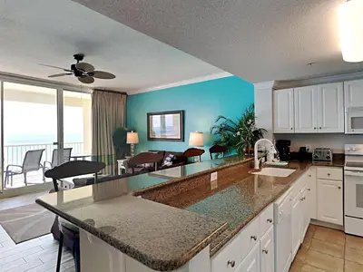 a kitchen with a view of a living room at Majestic Beach Towers I #1505 in Panama City Beach