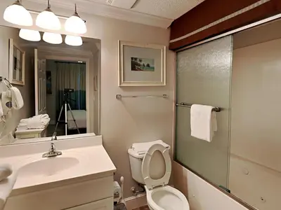a bathroom with a toilet and a sink and a shower at Majestic Beach Towers I #1505 in Panama City Beach