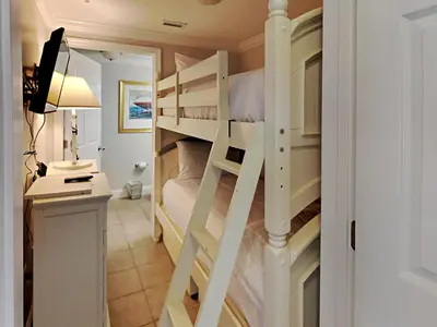 a bedroom with bunk beds with a desk and a computer at Majestic Beach Towers I #1505 in Panama City Beach