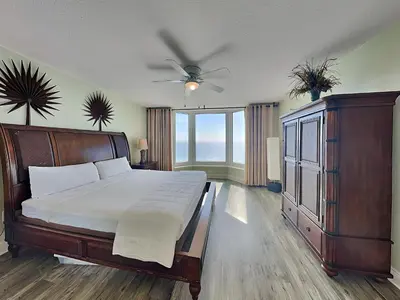 a bedroom with a bed and a ceiling fan at Emerald Beach #1531 in Panama City Beach