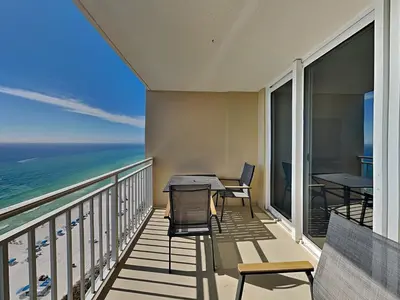 a balcony with a table and chairs and the ocean at Emerald Beach #1531 in Panama City Beach