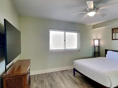 a bedroom with a bed and a ceiling fan at Emerald Beach #1531 in Panama City Beach