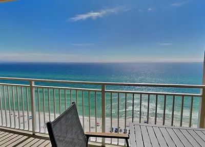 a chair sitting on a balcony overlooking the ocean at Emerald Beach #1531 in Panama City Beach