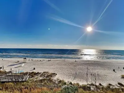 a beach with people on the sand and the ocean at Majestic Beach Towers I #311 in Panama City Beach