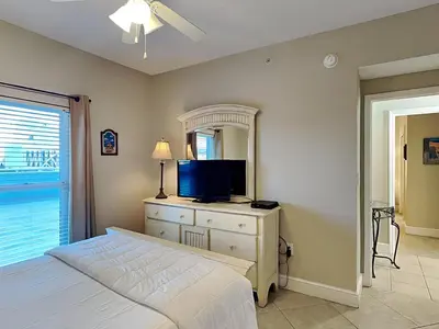 a bedroom with a bed and a tv on a dresser at Majestic Beach Towers I #311 in Panama City Beach