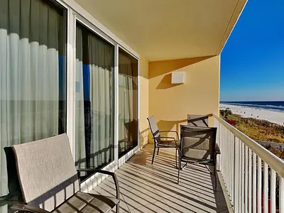a balcony with a table and chairs and the beach at Majestic Beach Towers I #311 in Panama City Beach
