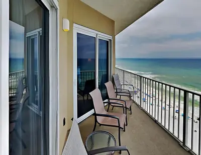 a balcony with chairs and a view of the ocean at Grandview East #1305 in Panama City Beach