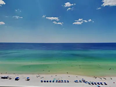 a view of a beach with umbrellas and the ocean at Grandview East #1305 in Panama City Beach