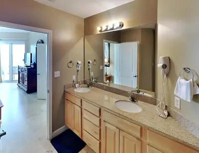 a bathroom with two sinks and a large mirror at Grandview East #1305 in Panama City Beach