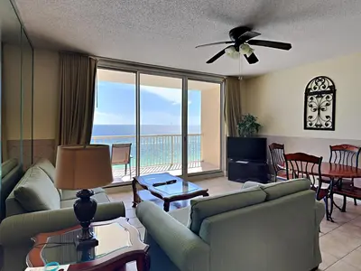 a living room with a couch and a view of the ocean at Majestic Beach Towers I #914 in Panama City Beach